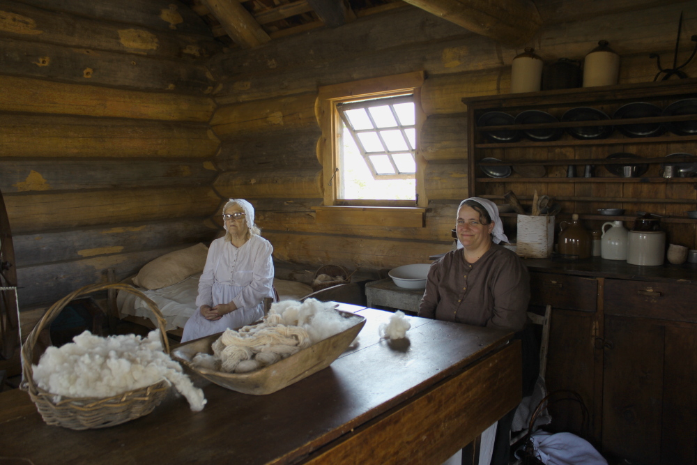 Preparing wool in the loghouse at the Highland Village